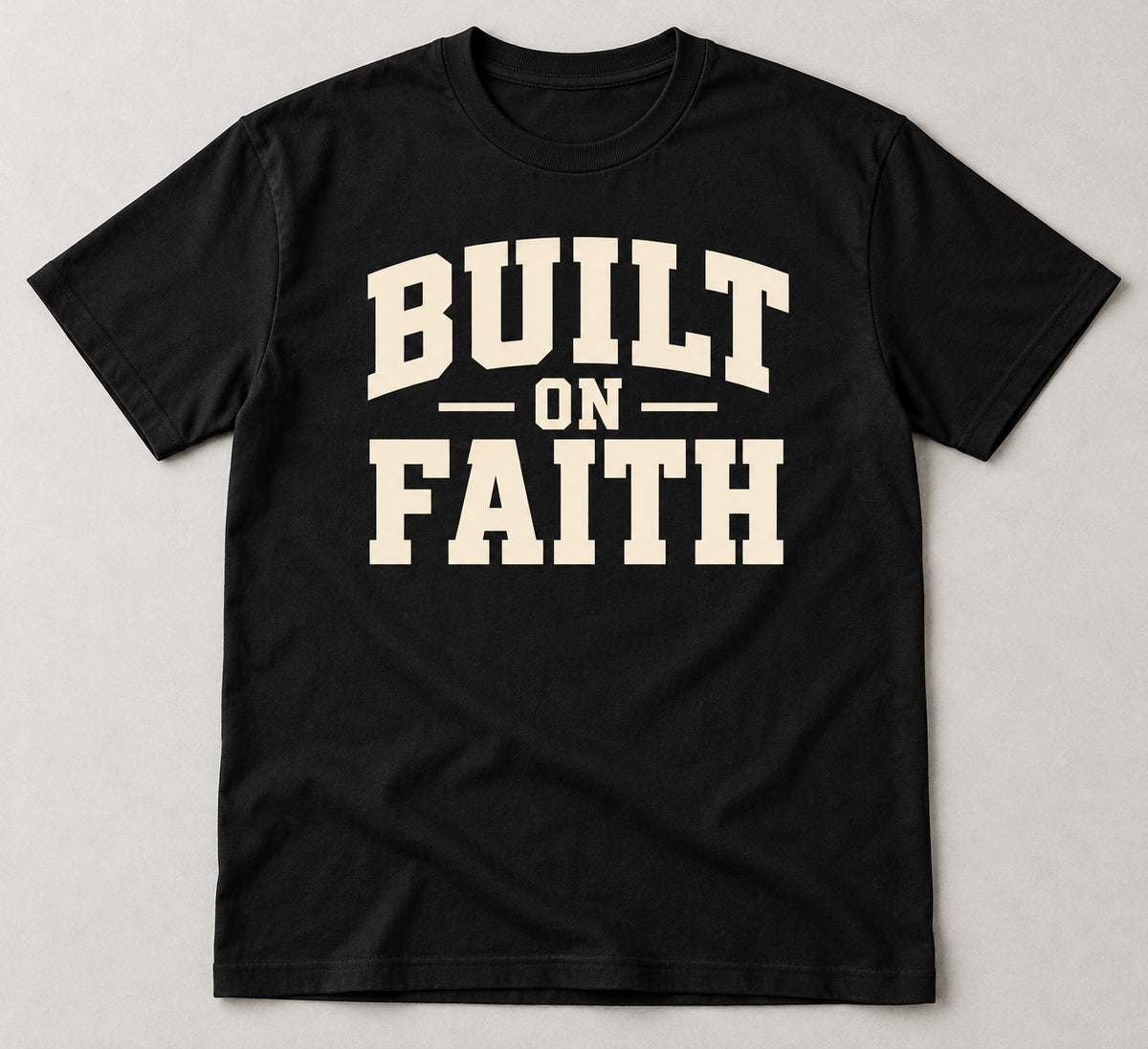 Black Built on Faith T-shirt mockup with cream-colored varsity-style lettering